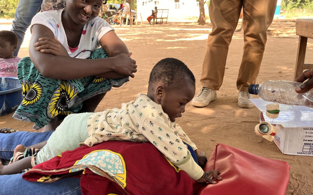 child playing on their stomach with mother smiling